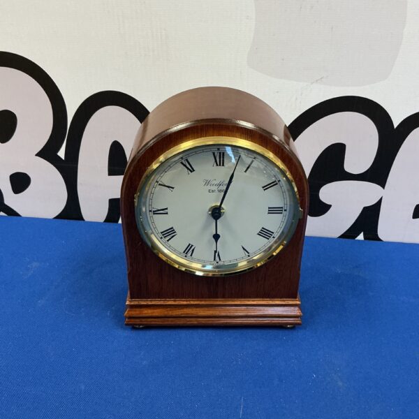 Front view of a classic Woodford radio controlled wooden mantel clock.