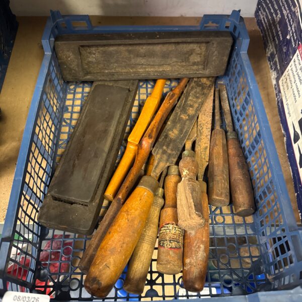 Vintage woodworking chisels and tools in a tray.