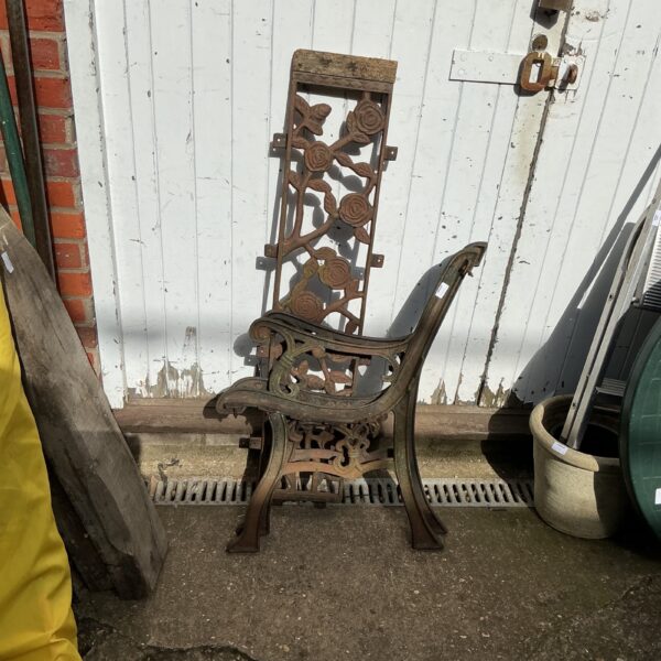 Intricate floral detailing on antique wrought iron garden bench.