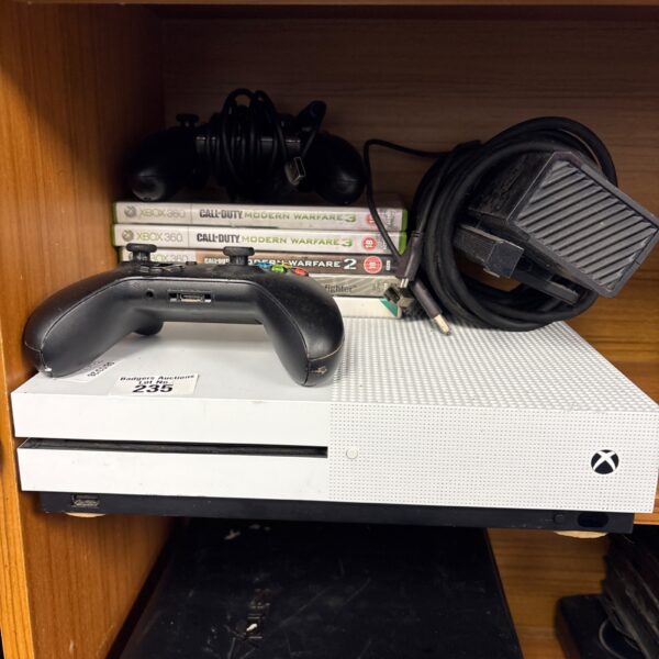 Xbox One S console bundle with games and controllers displayed.