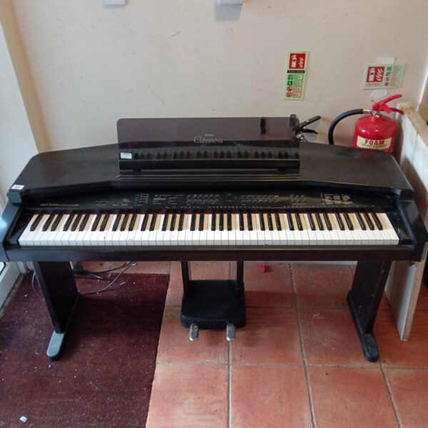 Yamaha Clavinova CVP-35 digital piano in a home setting.