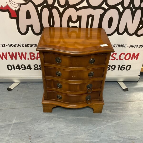 Antique yew wood serpentine chest of drawers with four drawers.