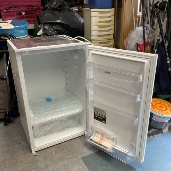 White Zanussi under counter fridge, compact kitchen appliance.