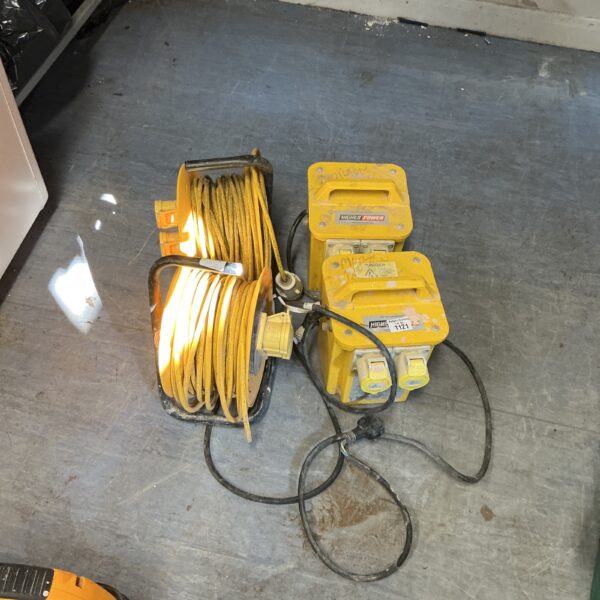 Yellow 110v transformer with coiled extension lead for site work.
