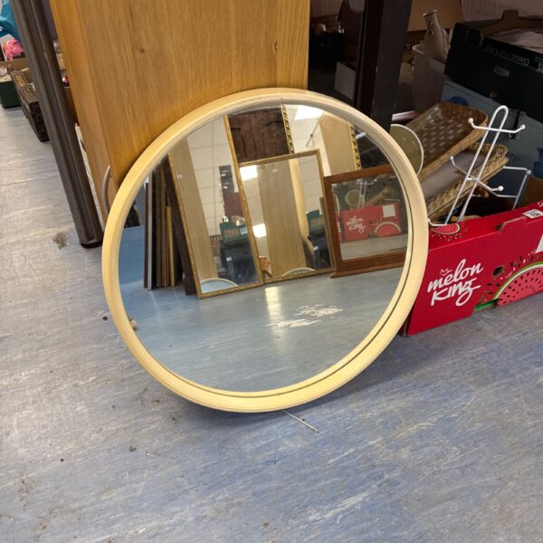 Vintage 1970s circular mirror for retro home decor.