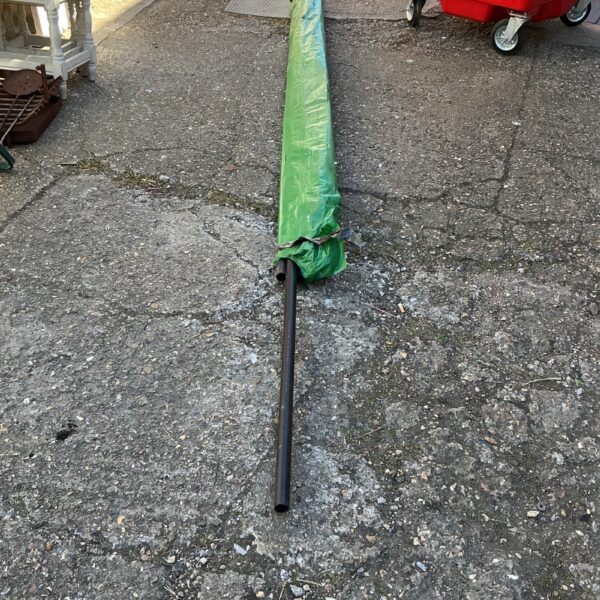 Rolled green 32mm Floplast pipe on gravel surface.