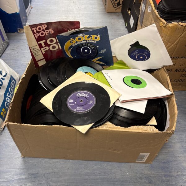 Large lot of 60s vinyl singles in paper sleeves.