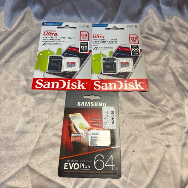 Lot of three 64GB Micro SD cards with adapters for expanded storage.