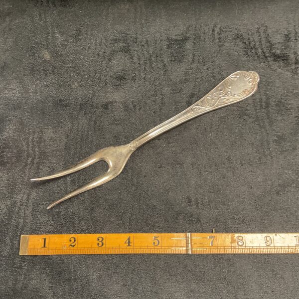 Ornate 800 silver serving fork with detailed handle.