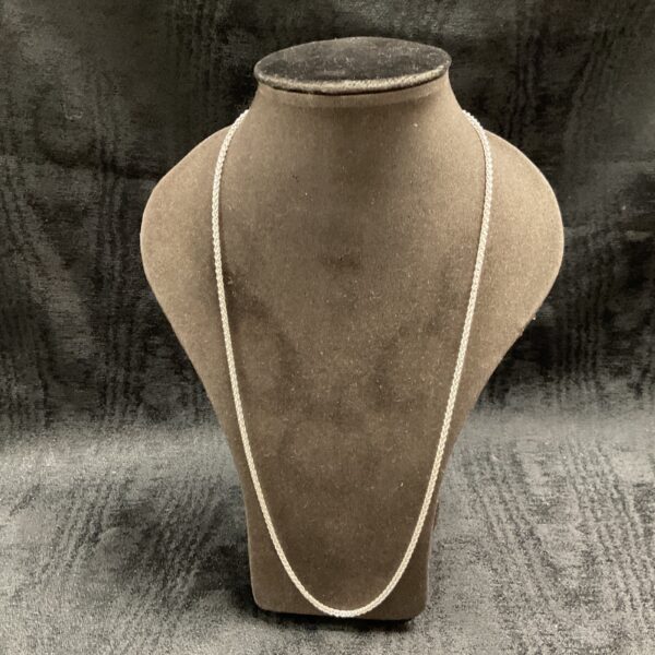 Close-up of a 925 silver rope chain necklace on a display stand.