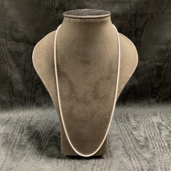 Close-up of a 925 silver rope chain necklace on a display bust.