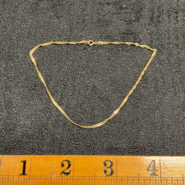Delicate 9ct gold ankle bracelet, a classic fashion jewellery piece.