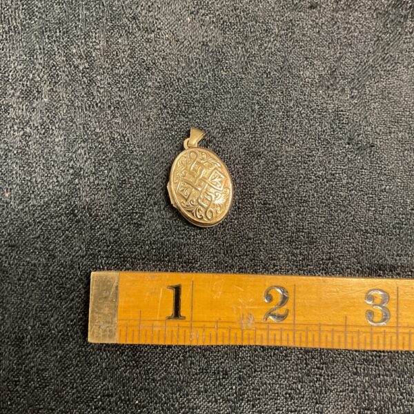 Close-up of a 9ct gold heart-shaped locket pendant.
