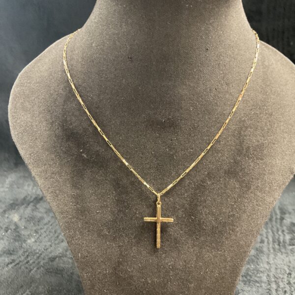 9ct gold necklace with cross pendant on display.
