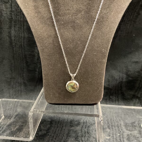 Silver necklace with iridescent abalone shell pendant.