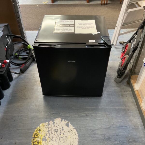 Compact Abode undercounter freezer in a utility room setting.
