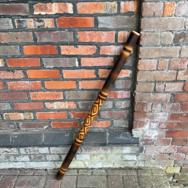 Hand-painted Aboriginal didgeridoo, traditional Australian Yidaki instrument.