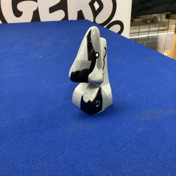 White and black abstract nose sculpture, modern art piece.