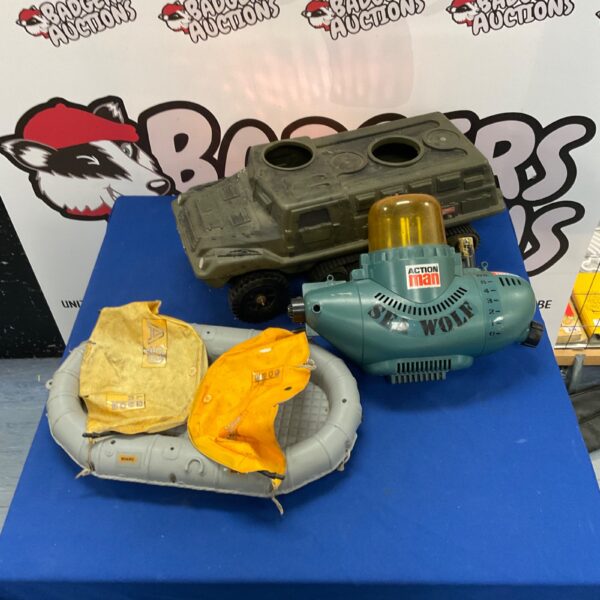 Vintage Action Man vehicles including Sea Wolf, raft and armored truck.