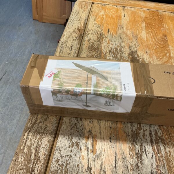 Aluminium parasol still in its original packaging, ready for garden use.