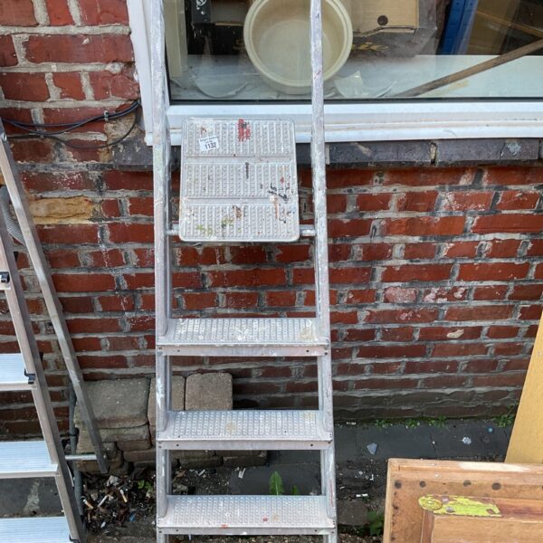 Silver aluminium step ladder with three steps, side view.