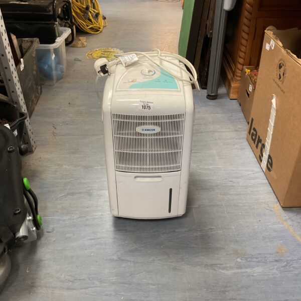 White Amcor portable dehumidifier appliance for moisture removal.