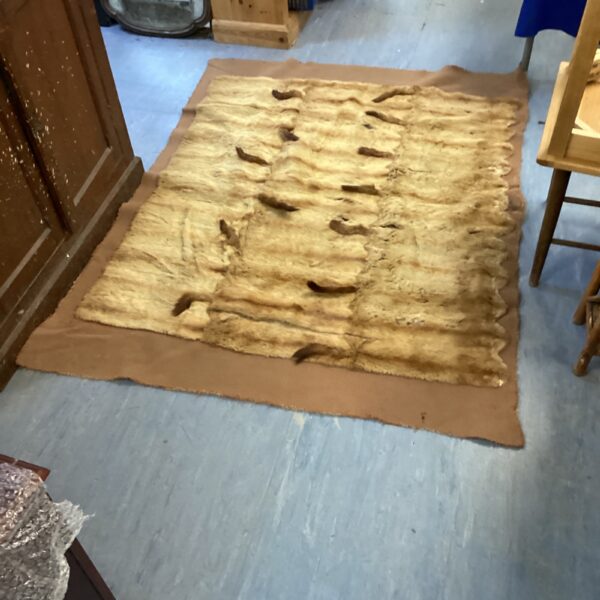 Close-up of a rustic animal fur rug with natural texture.