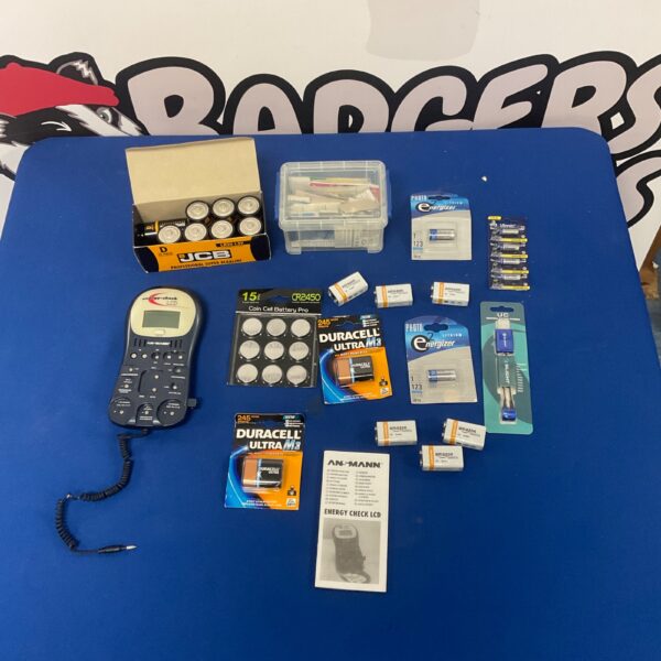 Ansmann battery tester with assorted batteries including Duracell and Energizer.