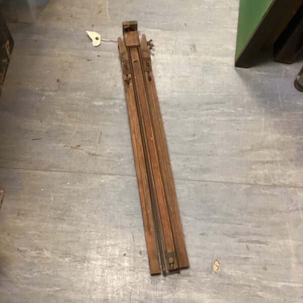 Antique wooden artist easel, showing signs of age and wear.