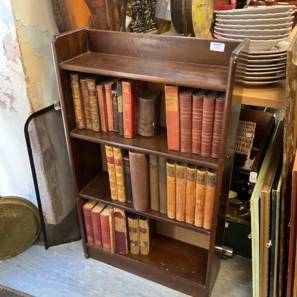 Antique wooden bookcase filled with vintage books, including Guizot’s works.