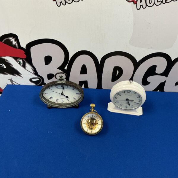 Antique brass mantel clock with white enamel dial.