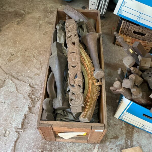 Crate of antique carved wood fragments, architectural salvage.