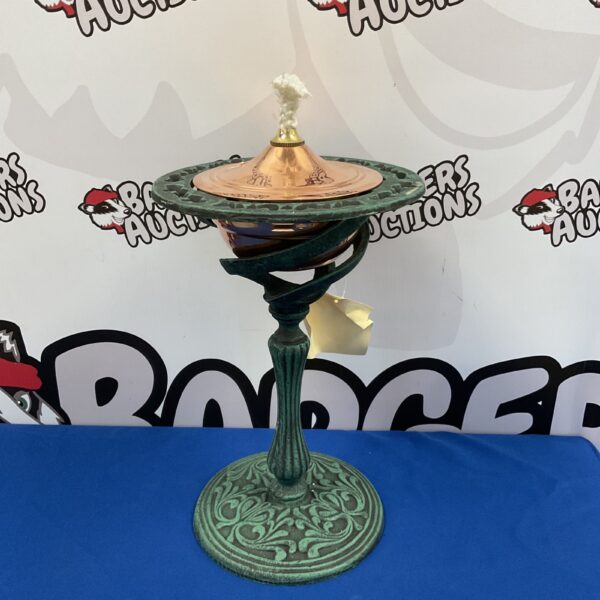 Antique cast iron table torch with copper details.