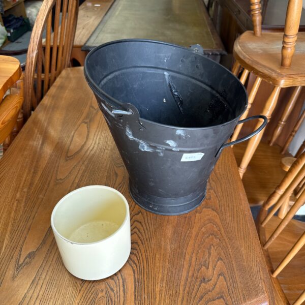 Black antique fire bucket with handle, vintage metal pail.