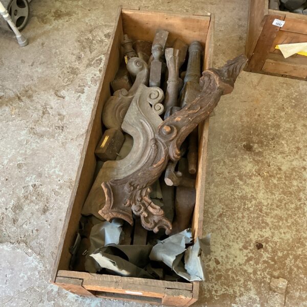 Crate of antique Victorian furniture carvings for restoration.