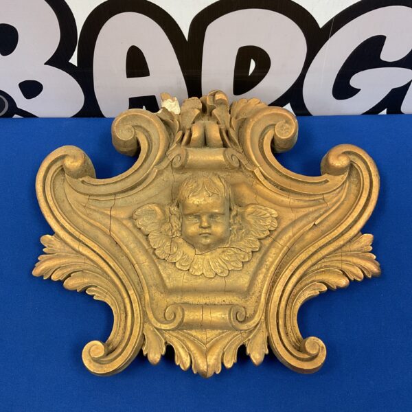 Antique gesso cherub plaque with floral details.