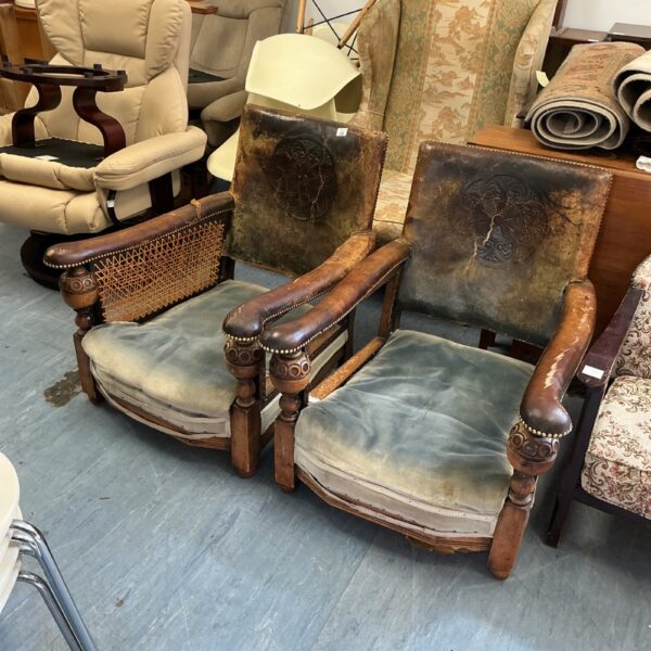 Pair of antique Grange club chairs showing wear.