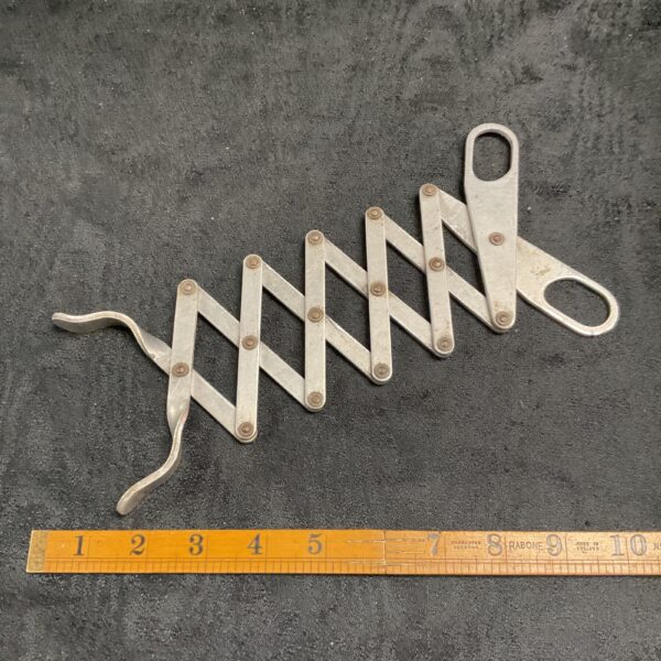 Antique lazy tongs, a vintage extending grabber tool for reaching.