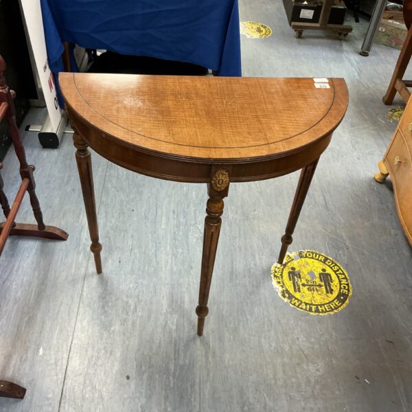 Antique mahogany console table with inlaid floral design.