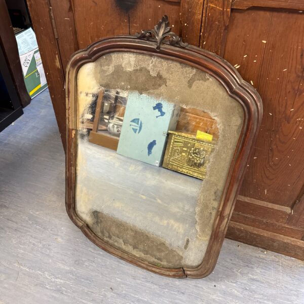 Ornate antique mahogany framed mirror with foxed glass.