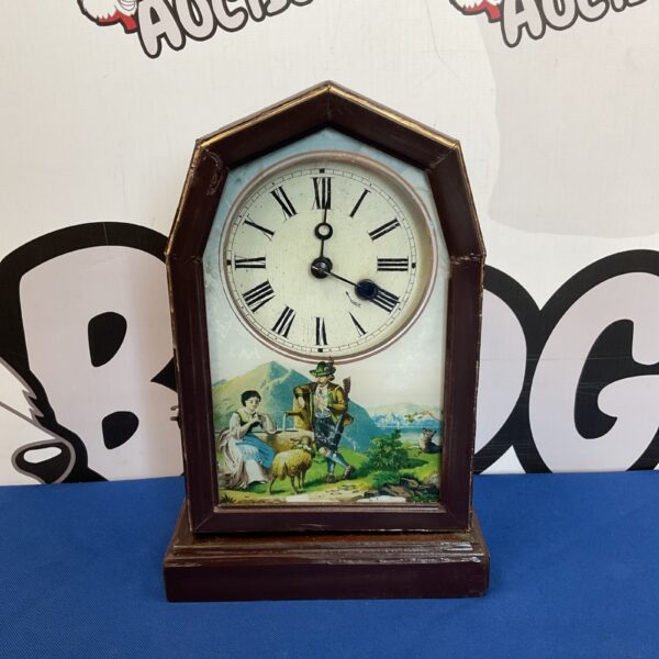 Antique mantle clock with Austrian scene painted on the door.