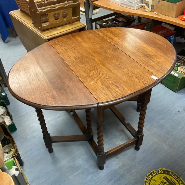 Antique oak barley twist gate leg table with folded legs.