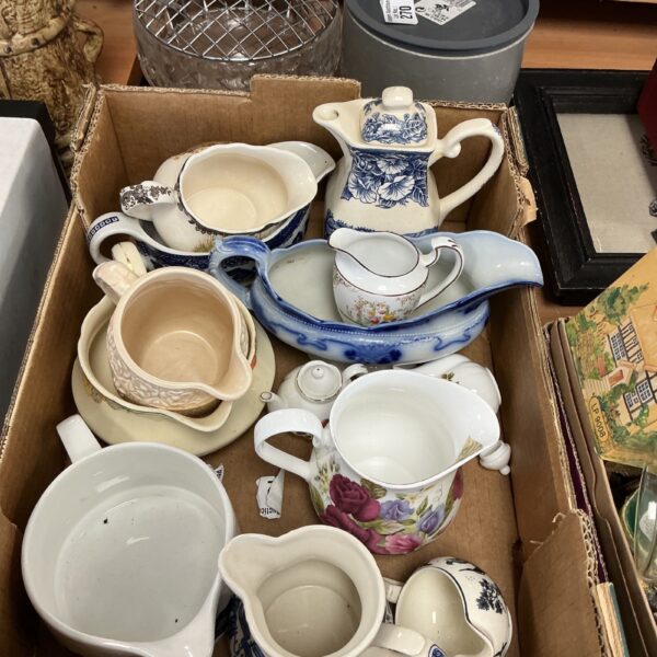 Antique porcelain jugs, including Royal Worcester, in a collection.