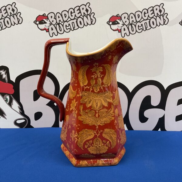 Antique red and gold jug with intricate Victorian pattern.