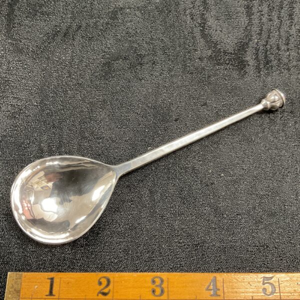 Antique sterling silver spoon with seal-top handle, front view.