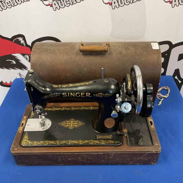 Antique Singer sewing machine with hand crank mechanism.