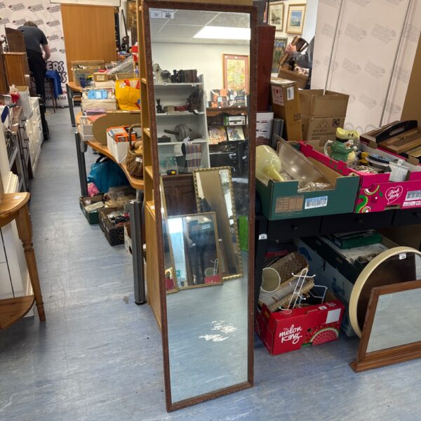 Ornate antique tall floor mirror with detailed wooden frame.