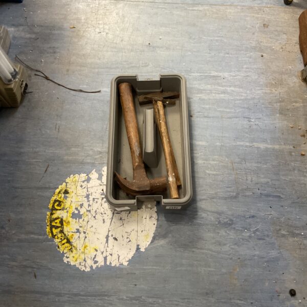 Antique tool lot featuring a vintage hammer and metal implements.