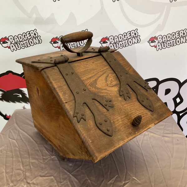 Antique wooden coal scuttle with wrought iron details.