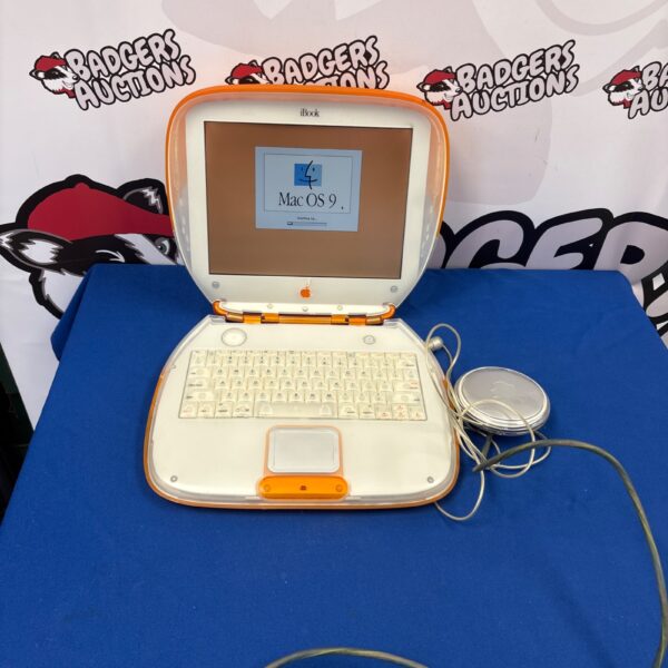 Vintage Apple iBook laptop displaying Mac OS 9 operating system.